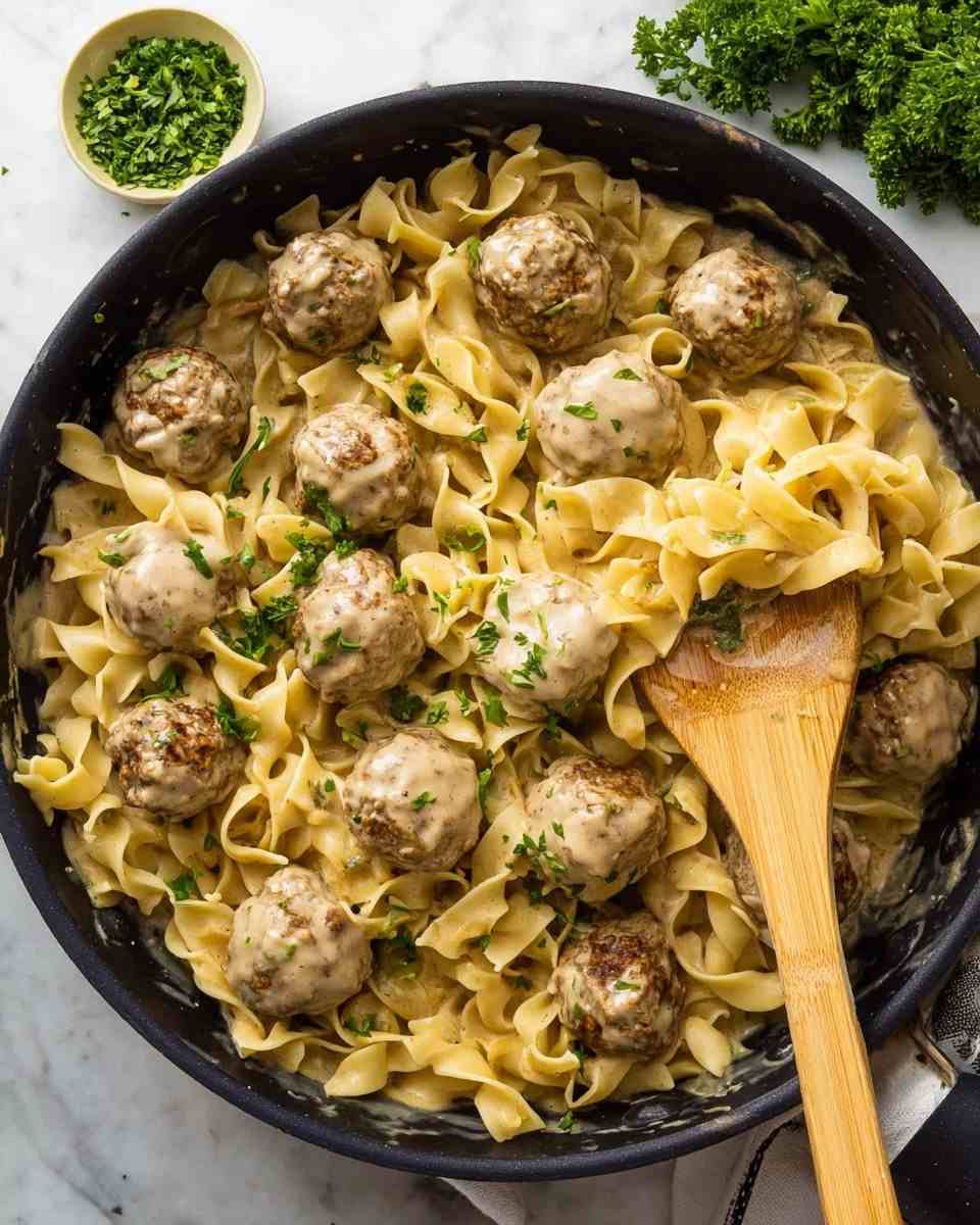 Golden Swedish meatballs atop buttery egg noodles, smothered in creamy gravy