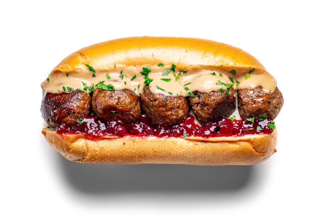Toasted baguette sub stuffed with savory Swedish meatballs, creamy gravy, and bubbling melted Swiss cheese