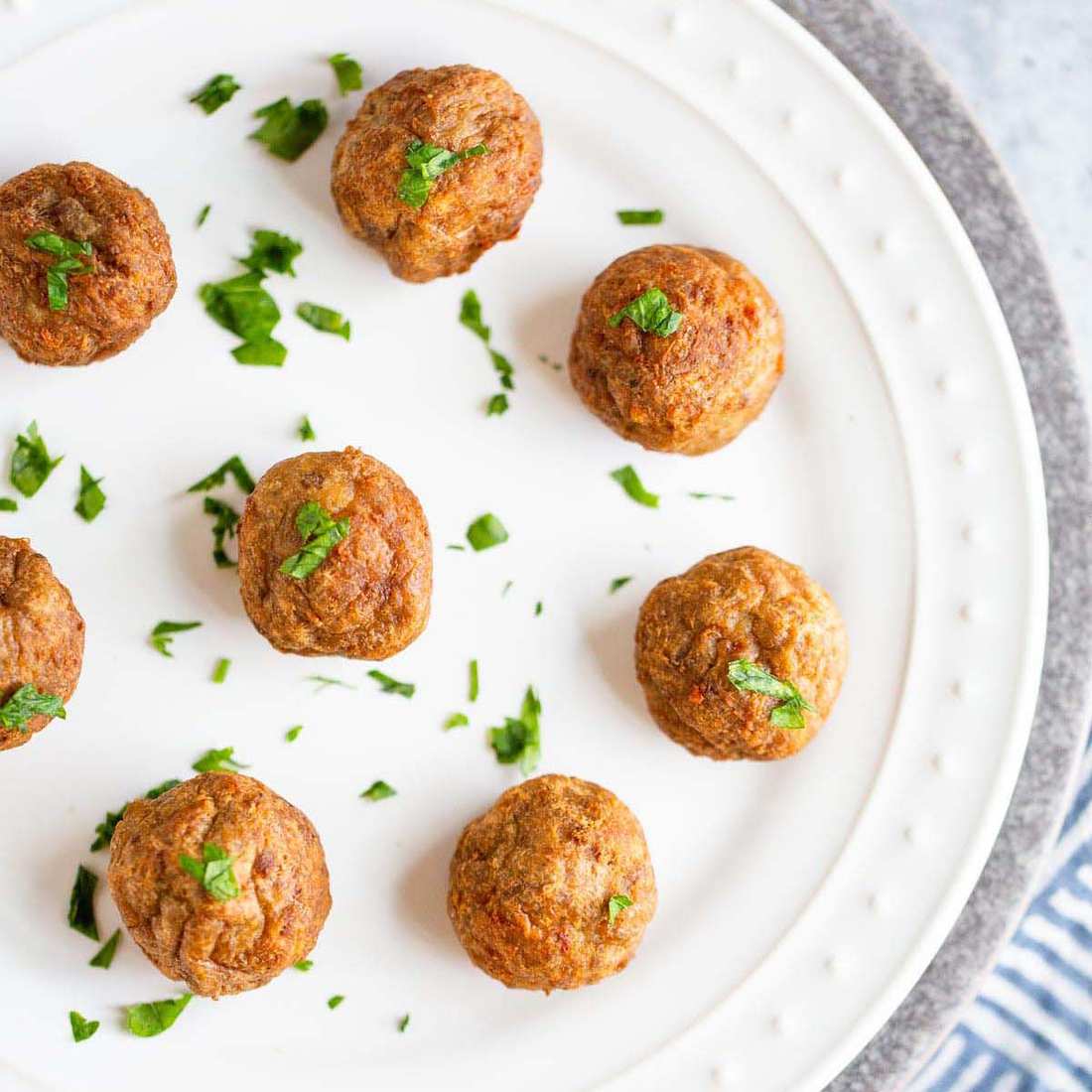 Air fryer basket filled with perfectly crisped golden-brown Swedish meatballs