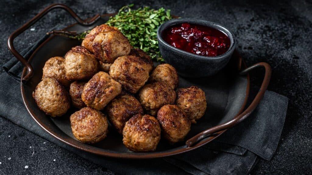 Swedish meatballs in silky brown cream gravy swirled with glossy red currant jelly