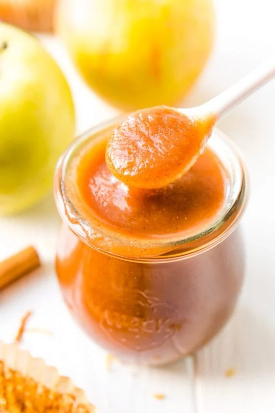 Slow cooker apple butter bubbling, caramel apple scent, cinnamon, cloves in a mason jar
