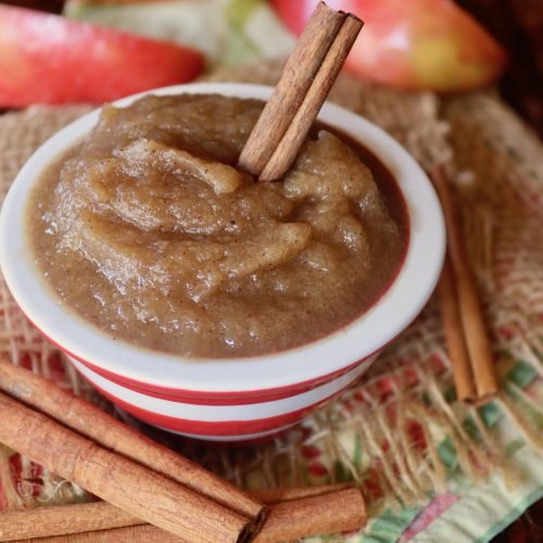 Creamy apple butter in a mason jar, golden hue, aromatic spices, perfect for autumn spreads