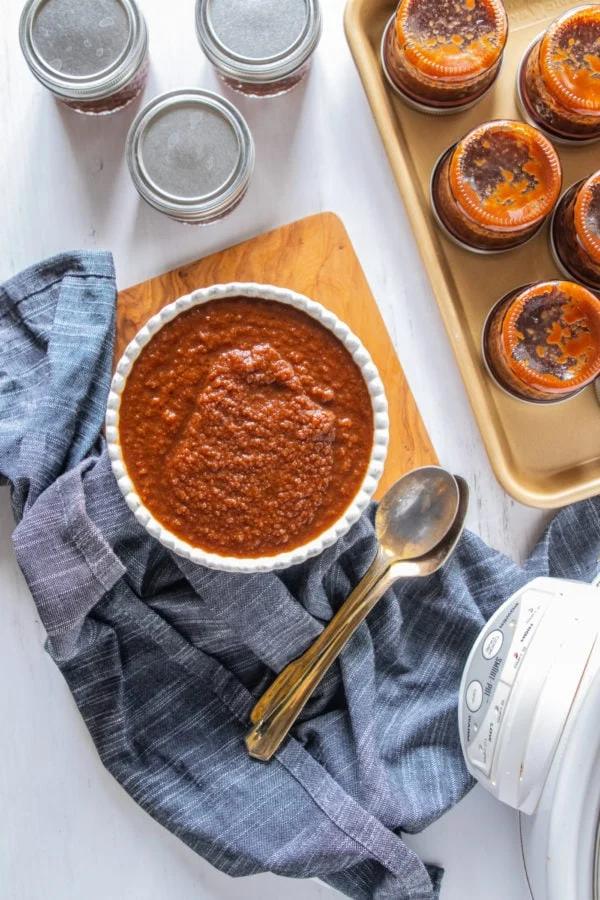 Rich apple butter with hints of cinnamon and cloves, nestled in a mason jar