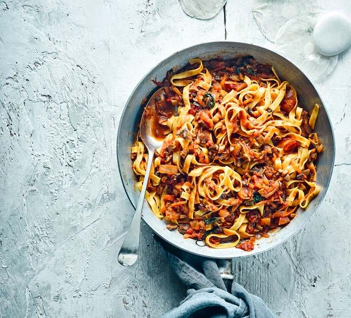 Creamy mushroom bolognese with earthy shrooms, tomatoes, and parmesan on pasta