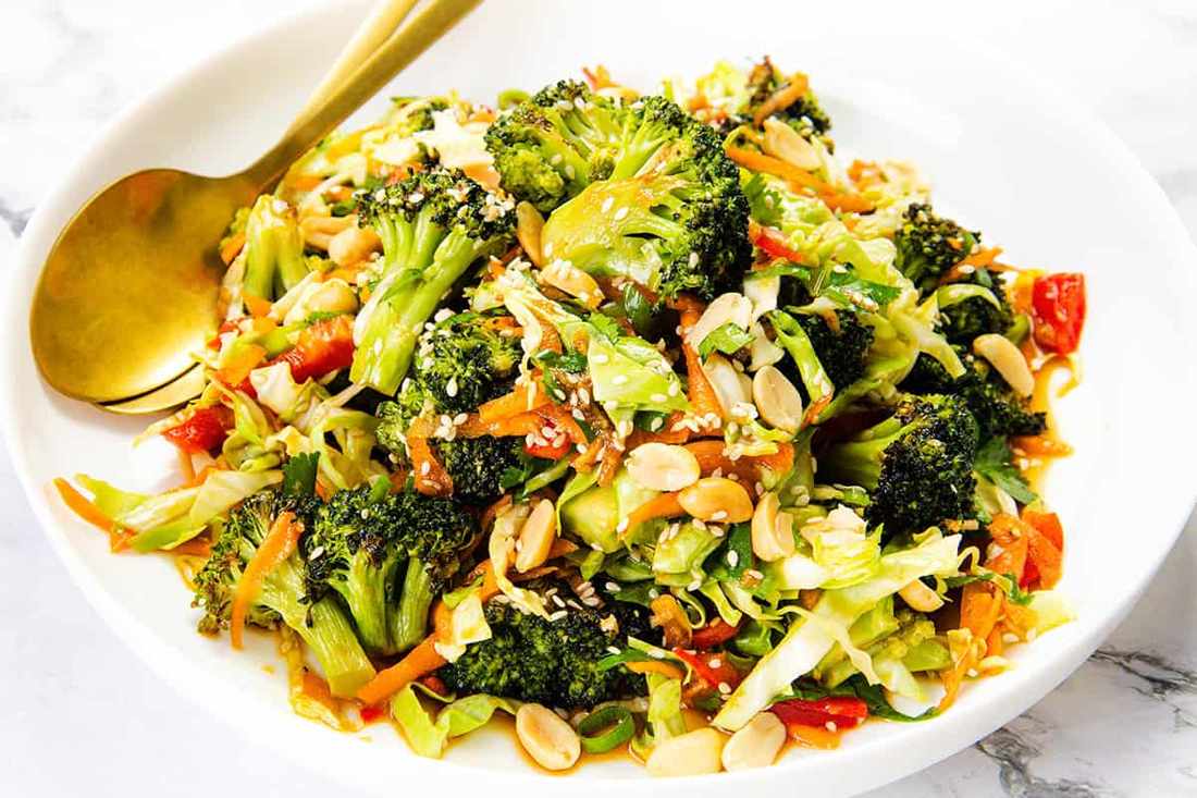 Sesame broccoli salad with lime juice, chili flakes, toasted peanuts, carrots, and a light soy dressing