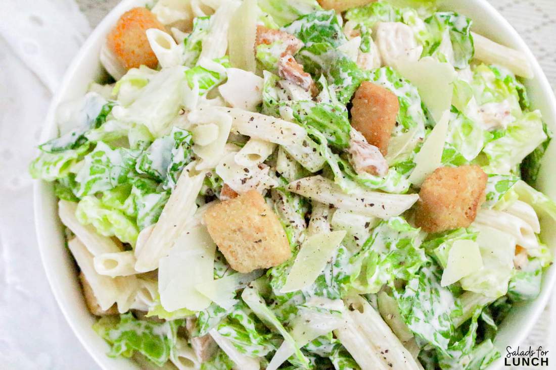 Flavorful chicken caesar pasta salad with crisp romaine, crunchy croutons, shaved parmesan, and creamy dressing.