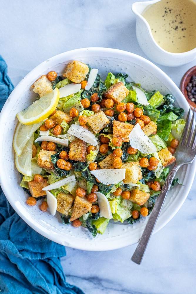 Fresh vegan caesar salad layered with crisp romaine, crunchy croutons, shaved parmesan, and creamy dressing.