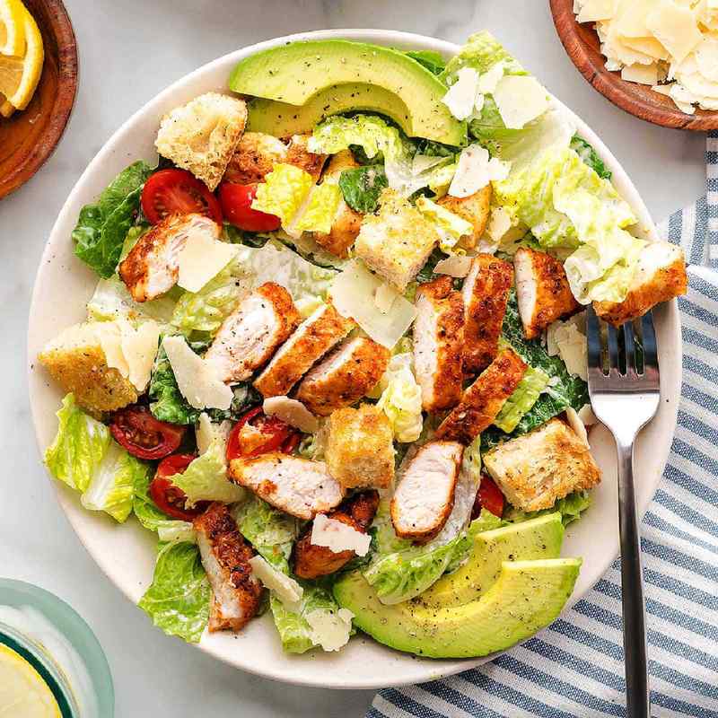 Blackened chicken caesar salad with crisp romaine, crunchy croutons, shaved parmesan, and creamy dressing.