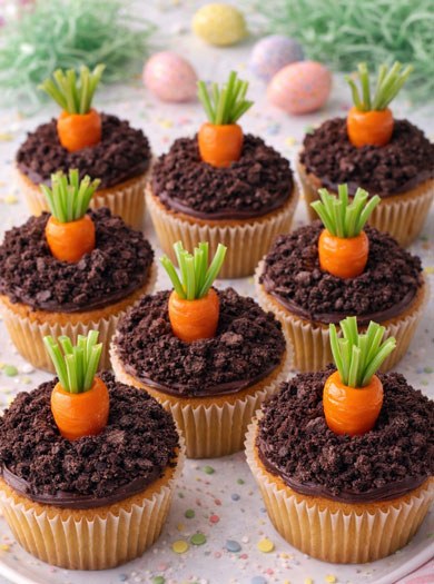 Gluten‑free carrot cupcakes crowned with colorful candy carrot decorations and cream cheese frosting