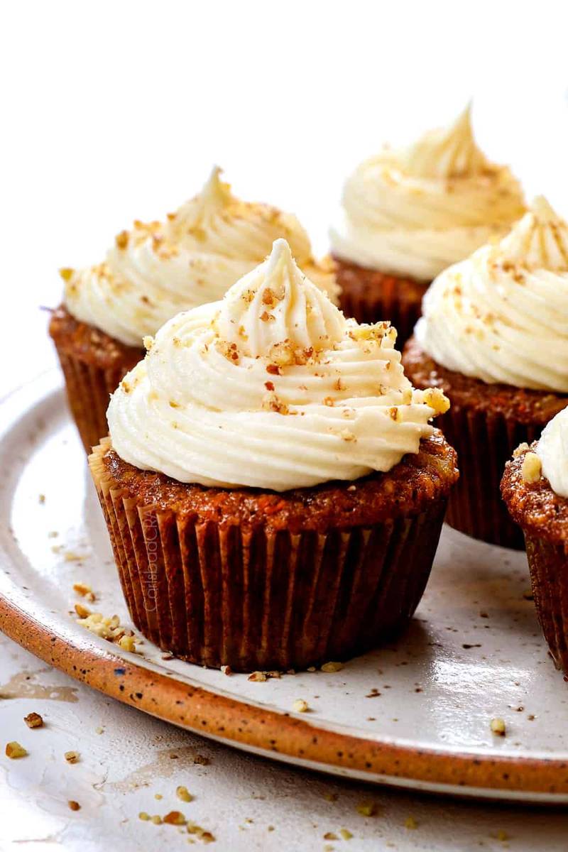 Moist carrot cupcakes topped with crunchy spiced crumb, sweet carrot flavor, and creamy frosting