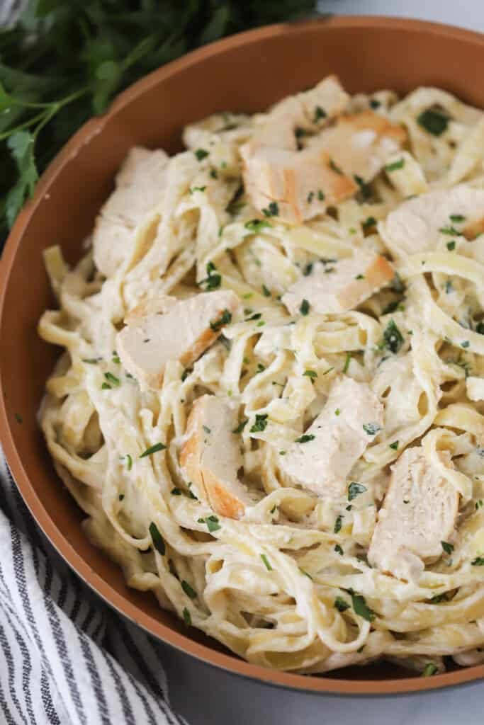 Classic fettuccine chicken alfredo with tender chicken and silky parmesan cream sauce, golden fettuccine