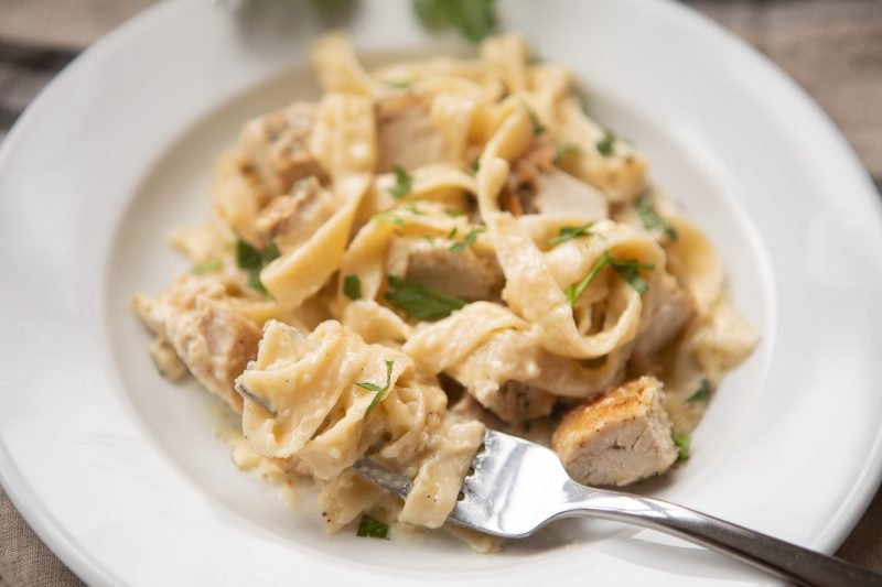 Gluten-free chicken alfredo featuring tender chicken tossed with silky parmesan cream sauce and fettuccine.