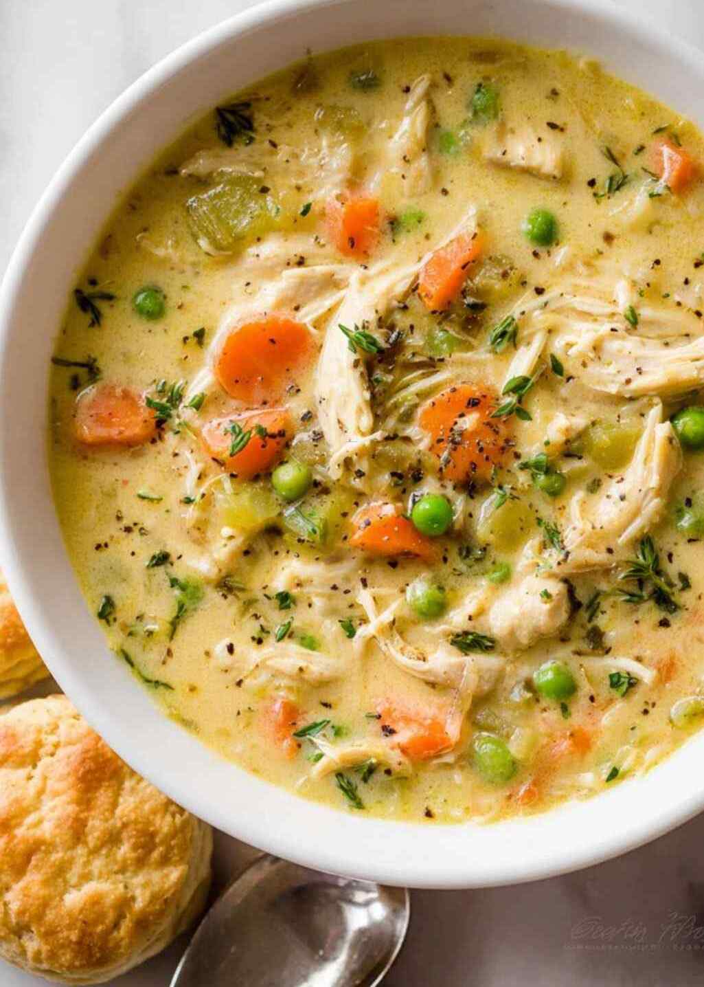 Creamy chicken pot pie soup with layered herbed phyllo crust, chicken, peas, carrots, potatoes