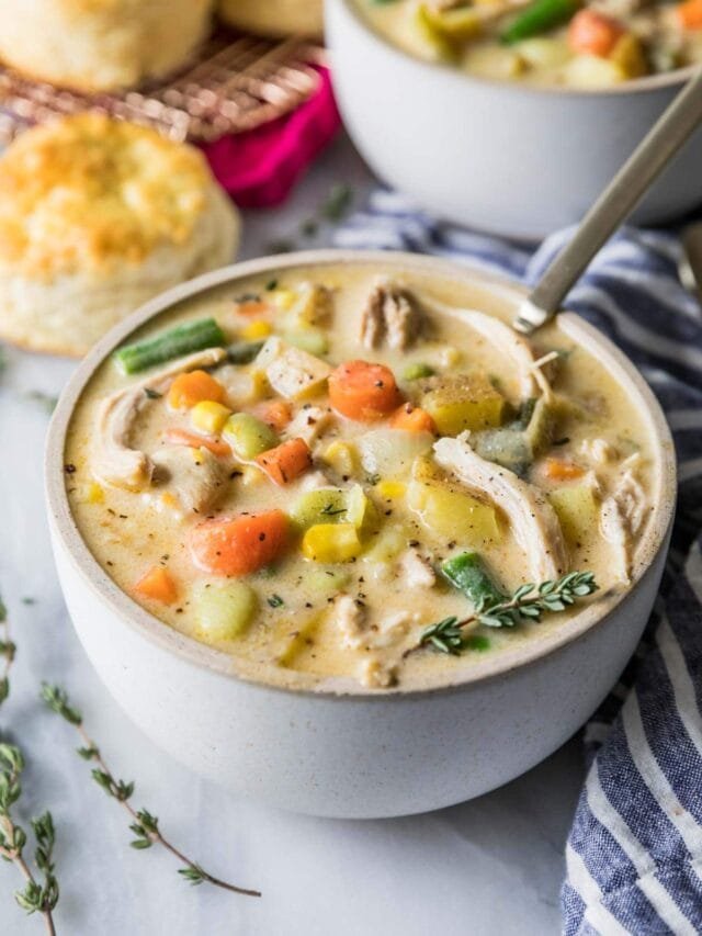 Creamy chicken pot pie soup featuring tender chicken, peas, carrots, potatoes, topped with puff pastry lattice