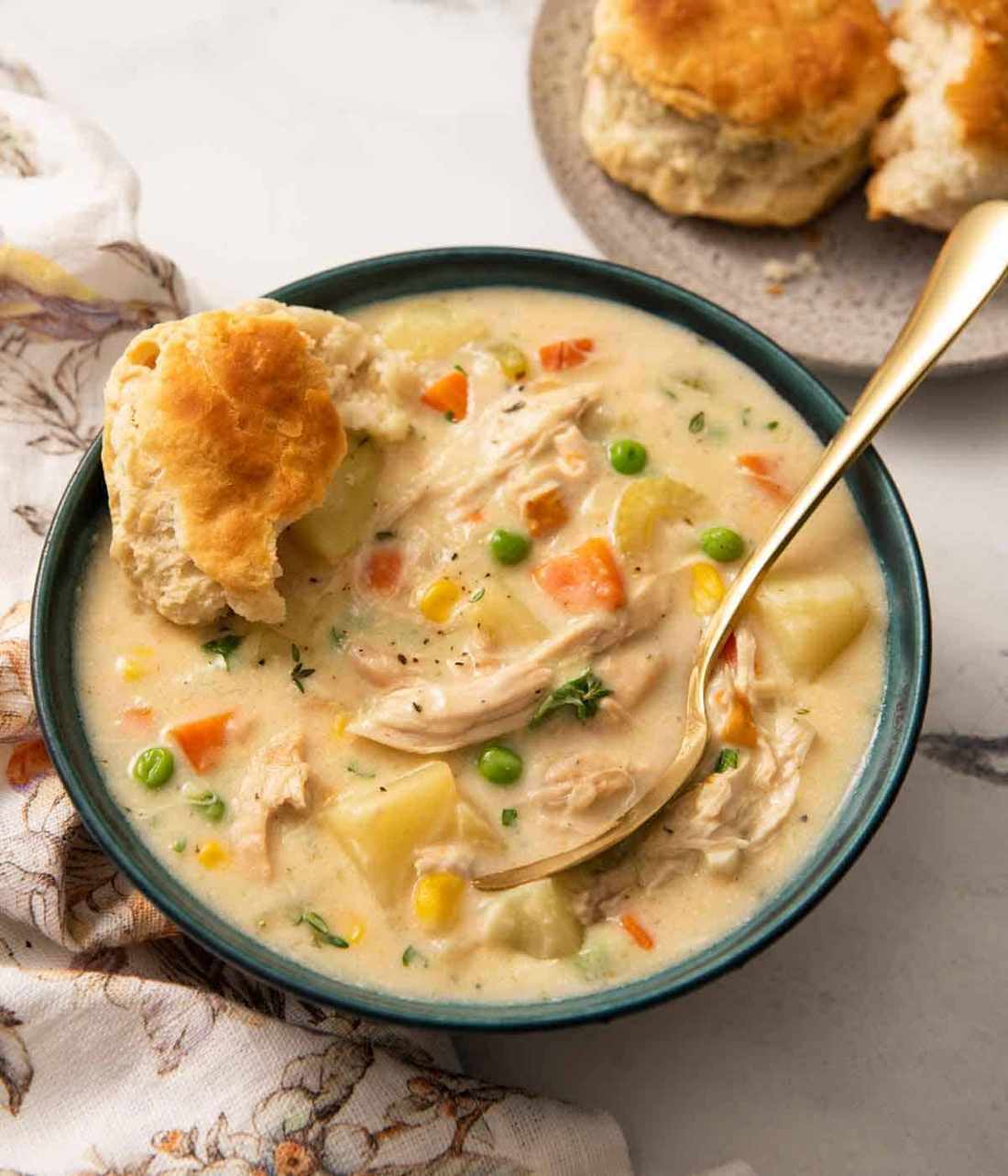 Creamy chicken pot pie soup topped with crispy Parmesan‑crusted croutons, peas, carrots, potatoes