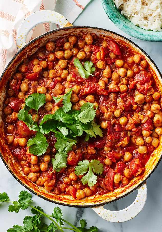 Slow simmered classic chana masala with spiced chickpeas, velvety curry sauce, fresh cilantro, warm naan.