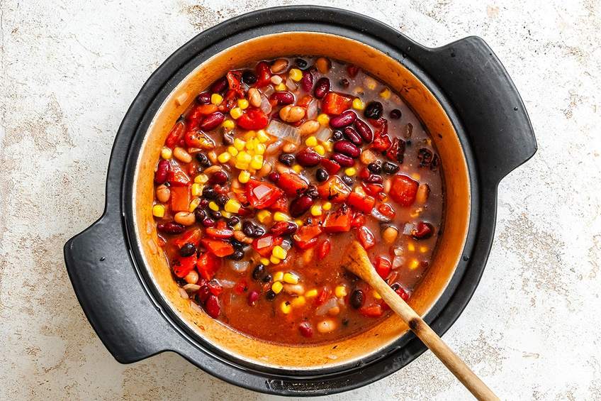 Triple bean smoky vegetarian chili topped with cheddar cheese and fresh green onions