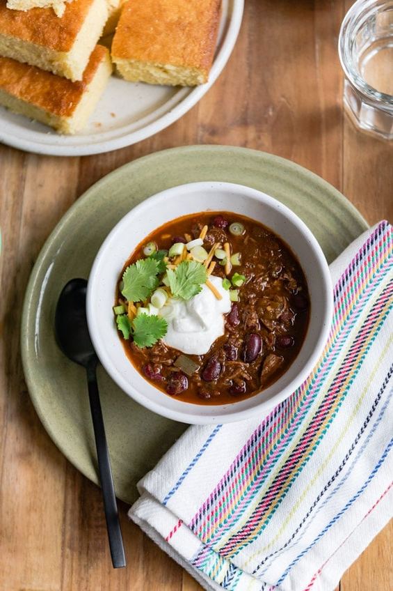 Hearty chili bowl with beef, beans, melted cheese, sour cream, jalapenos, cheddar‑infused topping