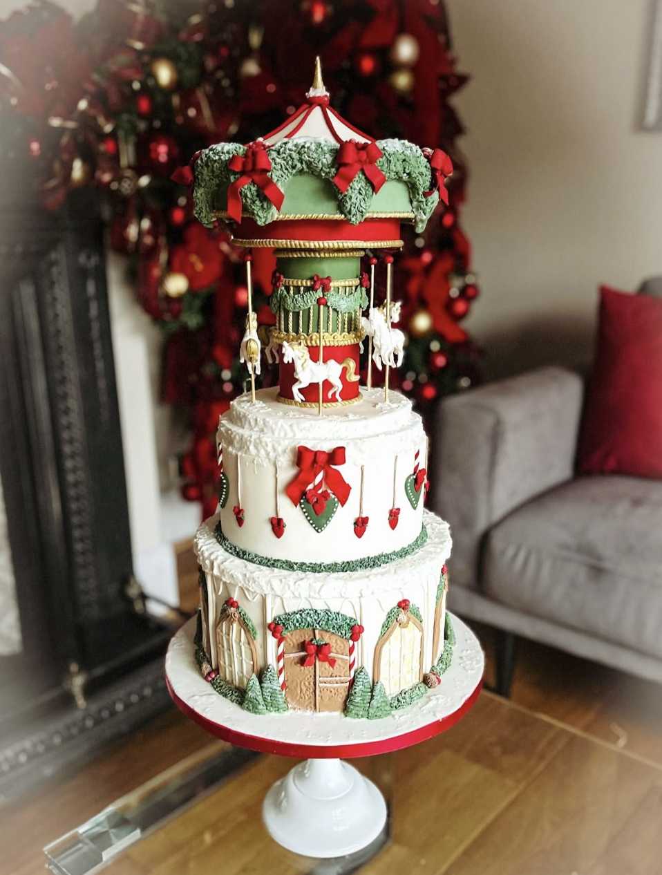 Three‑tiered pastel cake with carousel horses, ribbons, and glittering sugar pearls