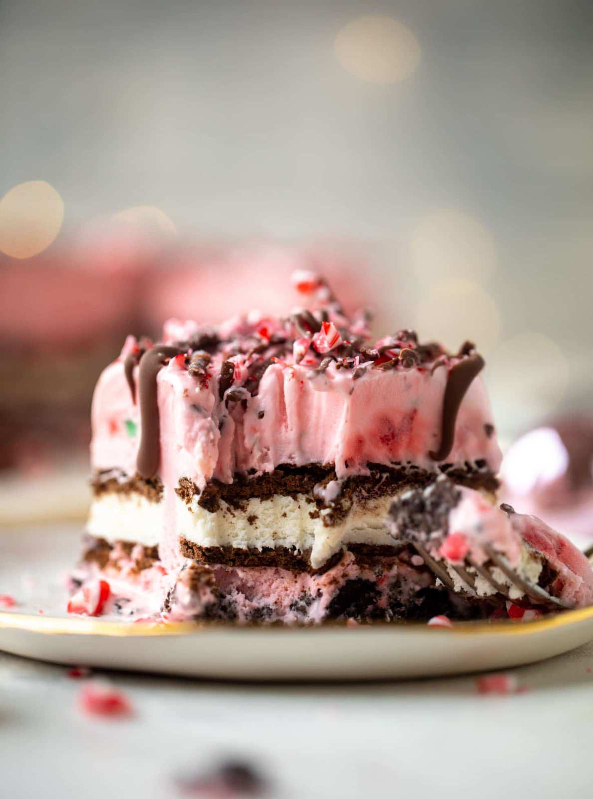 Layered chocolate wafer and peppermint whipped cream icebox cake, dusted with cocoa