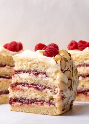 Light almond sponge cake with raspberry compote and almond buttercream frosting