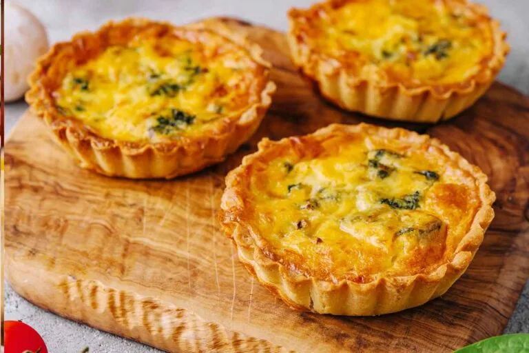 Golden mini tart shells filled with broccoli, cheddar, and custard