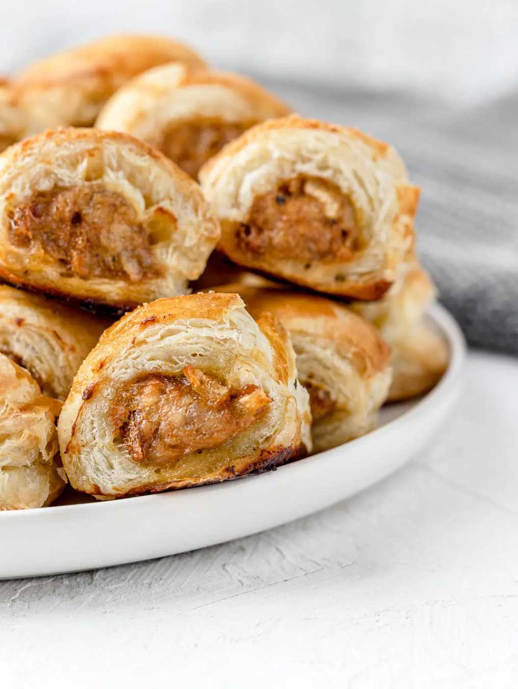 Golden mini sausage rolls made with flaky puff pastry and seasoned sausage