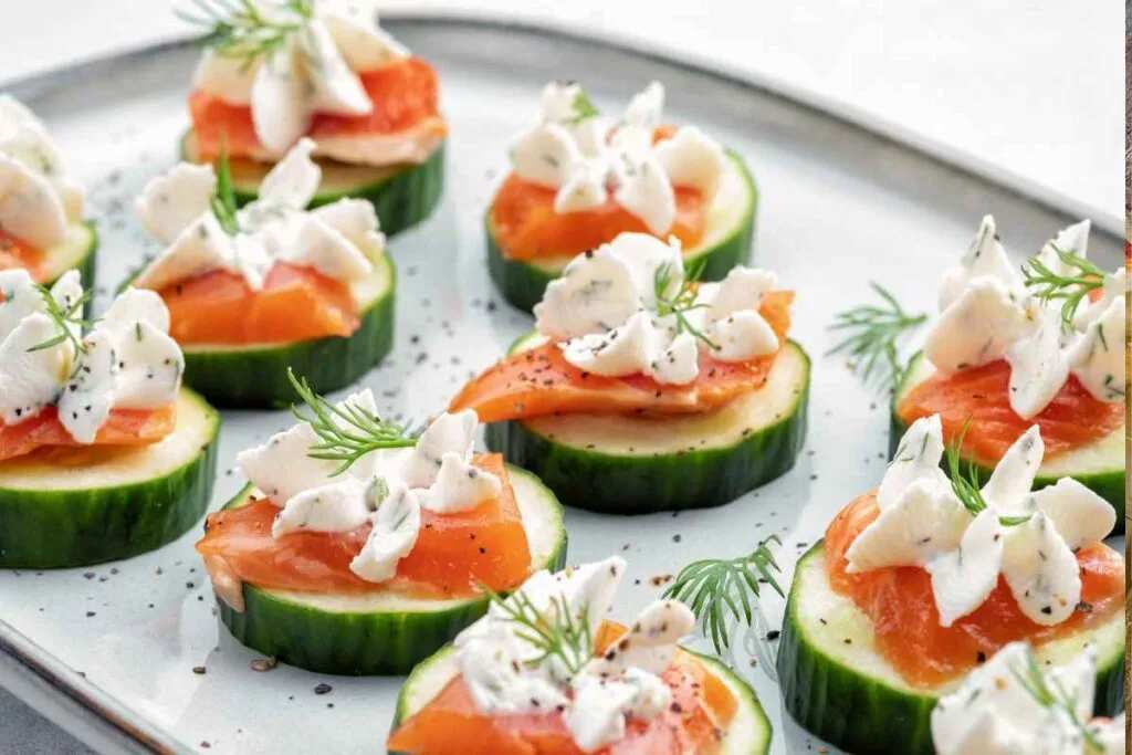 Fresh cucumber rounds topped with cream cheese and smoked salmon curls