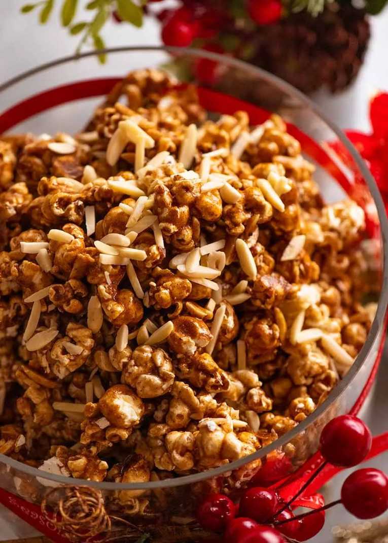Golden popcorn coated in caramel, toasted almonds, and a sprinkle of sea salt