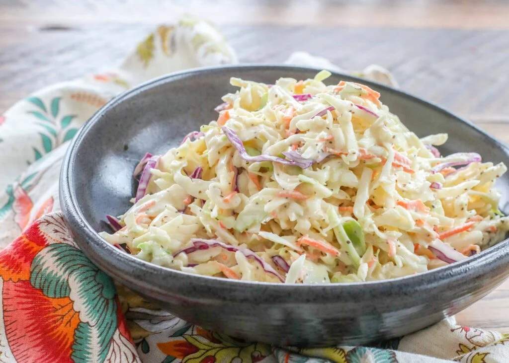 Classic creamy coleslaw with crisp cabbage and rich sour cream dressing delivering cool crunch
