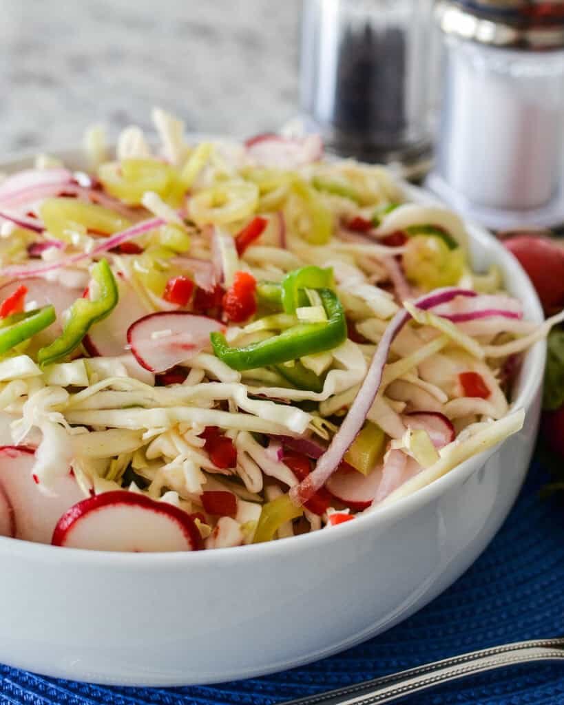 Lemon‑oregano vinaigrette over crisp cabbage, citrus zing, and aromatic herbs