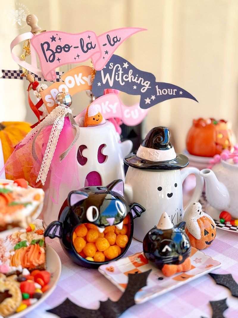 White ghost-shaped sugar cookies with simple black eyes and a cute smiling face