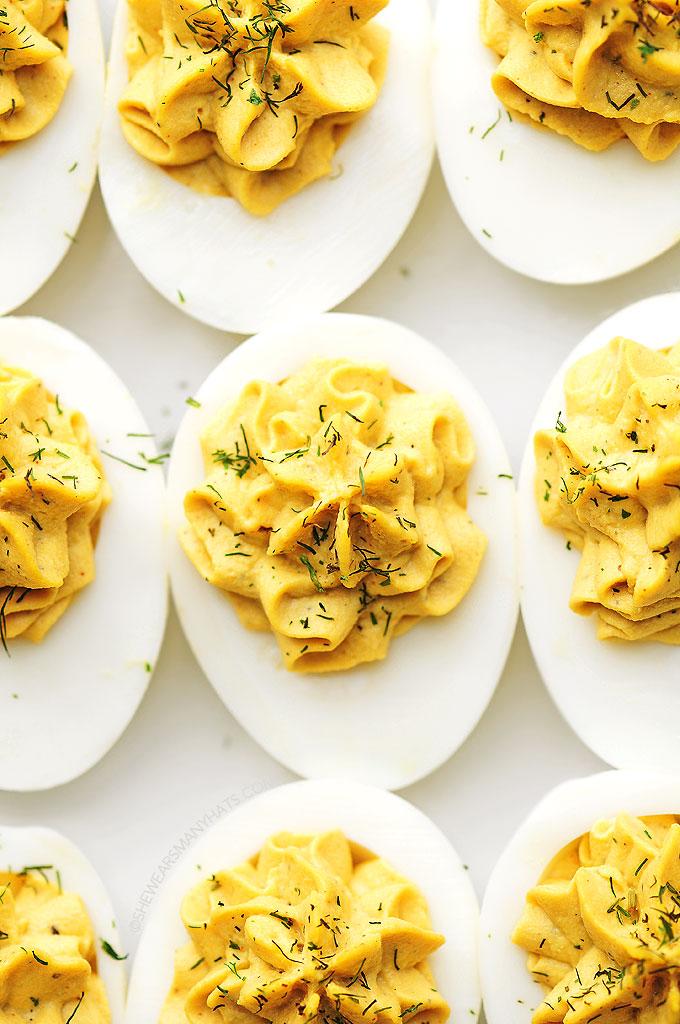 Creamy yolk filling with paprika, chives, and bacon bits on hard-boiled eggs