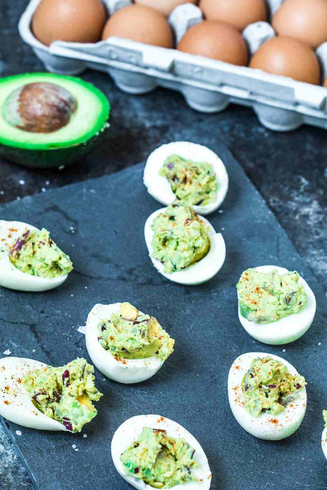 Classic deviled eggs, creamy yolk filling, dusted with paprika and topped with chives