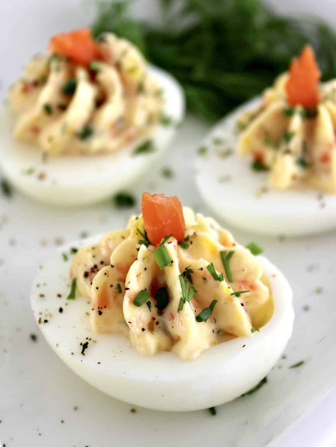 Deviled eggs topped with smoked salmon, horseradish cream, and chives