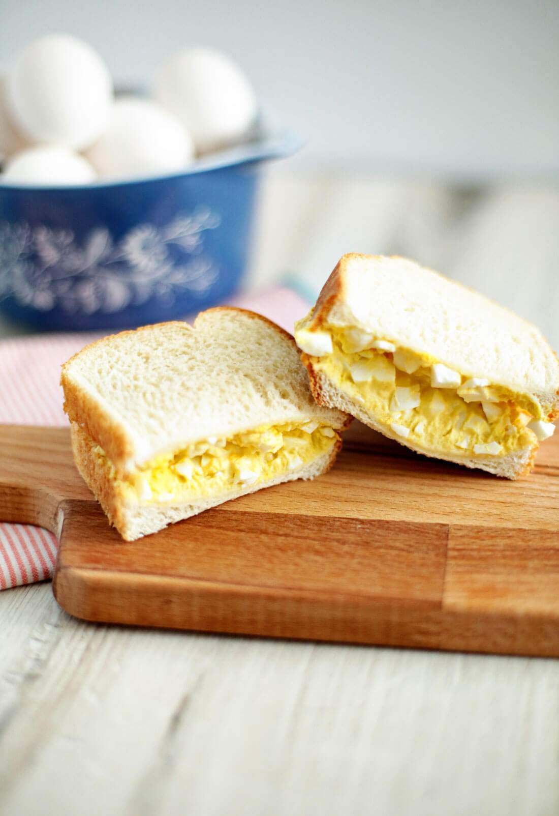 Classic creamy egg salad with chopped hard-boiled eggs, silky mayo, fresh herbs, served on a bed of greens