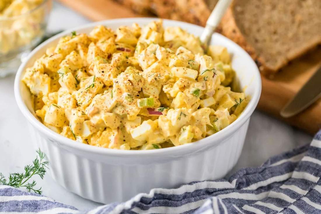 Classic creamy egg salad with chopped hard‑boiled eggs, mayo, herbs, served on fresh lettuce leaves