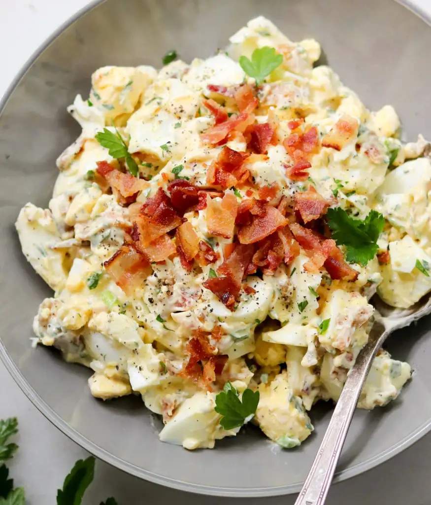 Classic creamy egg salad featuring diced hard‑boiled eggs, smooth mayo, aromatic herbs, and a pop of paprika garnish