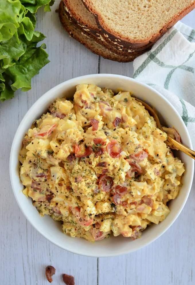 Classic creamy egg salad with chopped eggs, mayo, chives, smoked paprika, ready for sandwiches