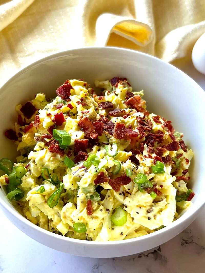 Classic creamy egg salad featuring chopped hard‑boiled eggs, velvety mayo, fresh chives, served in a rustic bowl