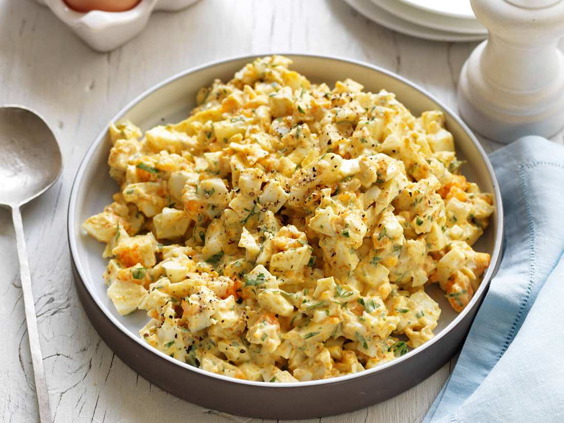 Curried egg salad with chopped hard-boiled eggs, creamy mayo, curry powder, fresh cilantro, and crisp lettuce leaves