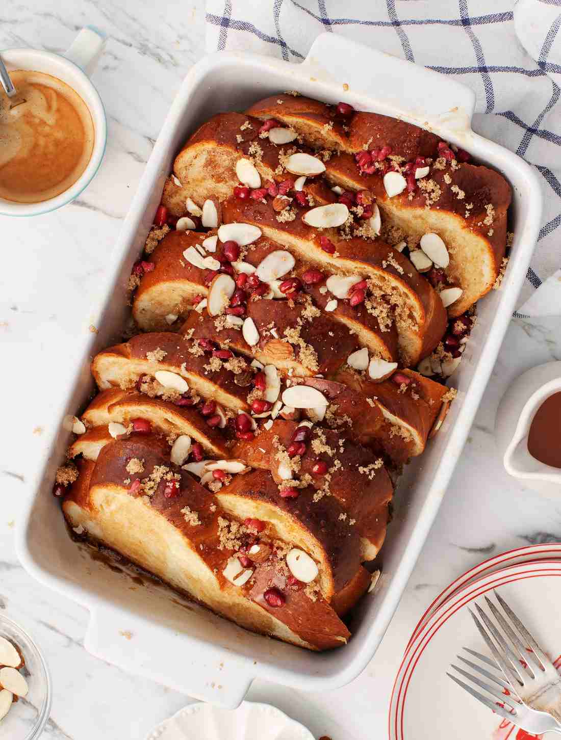 Golden custardy bread cubes steaming with maple syrup, surrounded by warm fruit, a mouth-watering French toast casserole