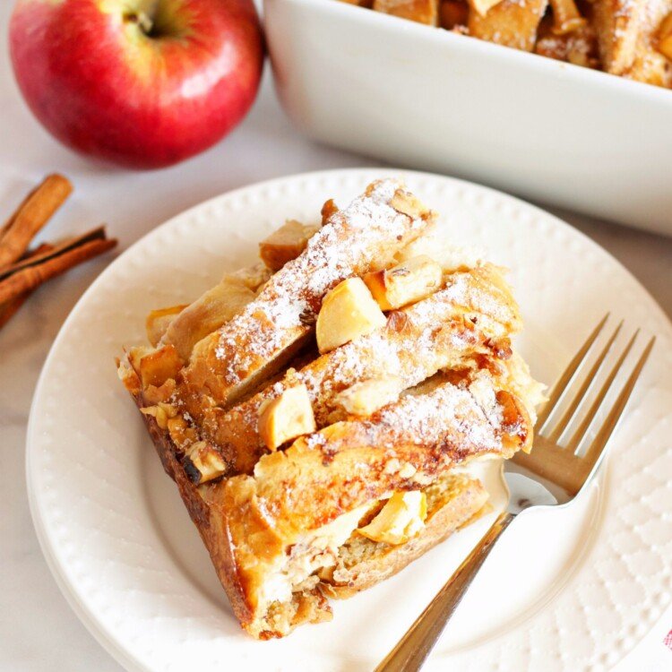Golden custardy bread cubes with warm apple slices, cinnamon swirl, topped with a drizzle of maple syrup