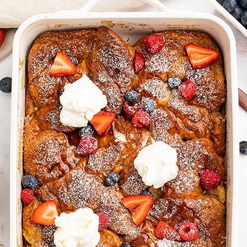 Croissant French Toast Casserole with flaky golden layers, custard filling, and a buttery finish
