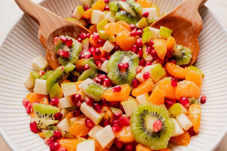 Christmas fruit salad with pomegranate, pear, kiwi, and a honey‑ginger dressing