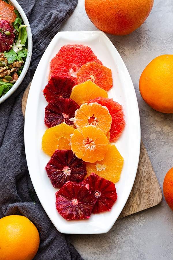 Mango honey citrus fruit salad with citrus segments, mango cubes, and a honey drizzle