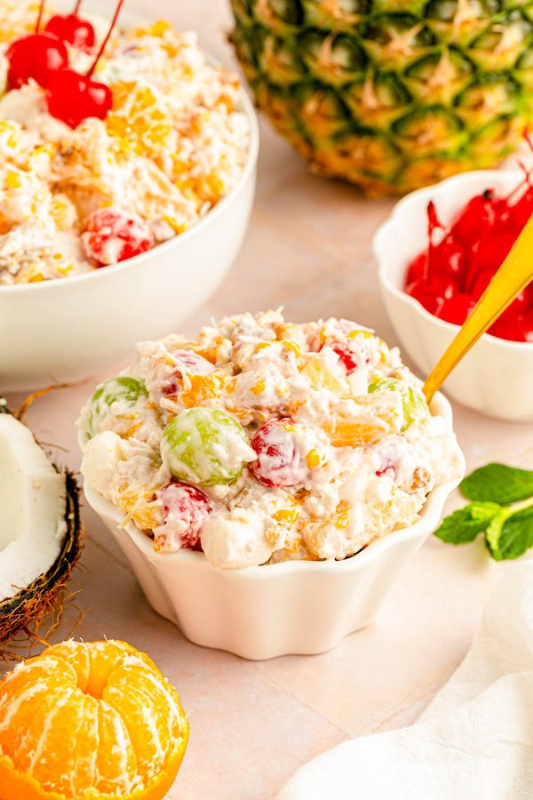 Creamy ambrosia fruit salad with ricotta, berries, mango, and toasted almonds