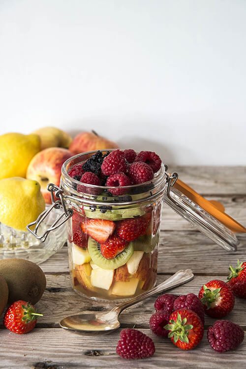 Mini fruit parfait jars layered with berries, mango, and a silky citrus‑cream drizzle