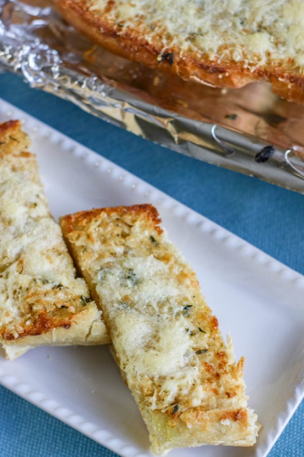 Classic garlic bread with golden crust, buttery garlic spread, and fragrant herbs