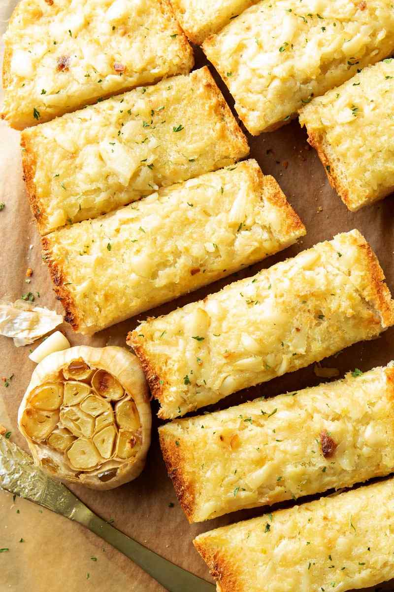 Roasted garlic bread topped with crispy Parmesan, golden crust, buttery garlic flavor
